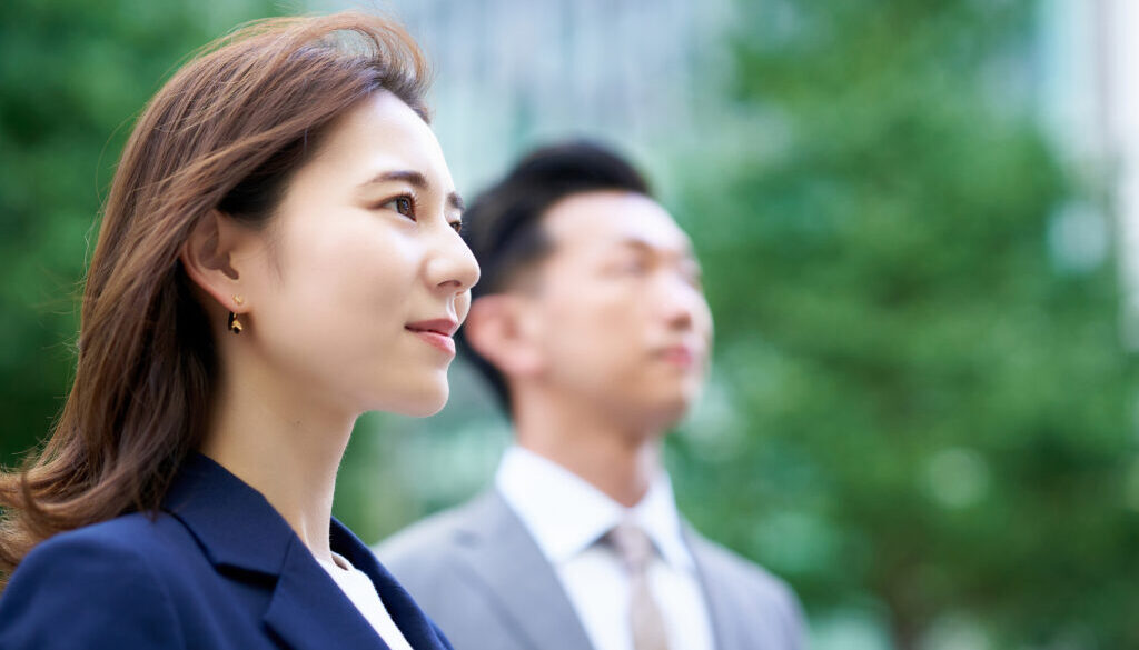 asian business man and woman outdoors