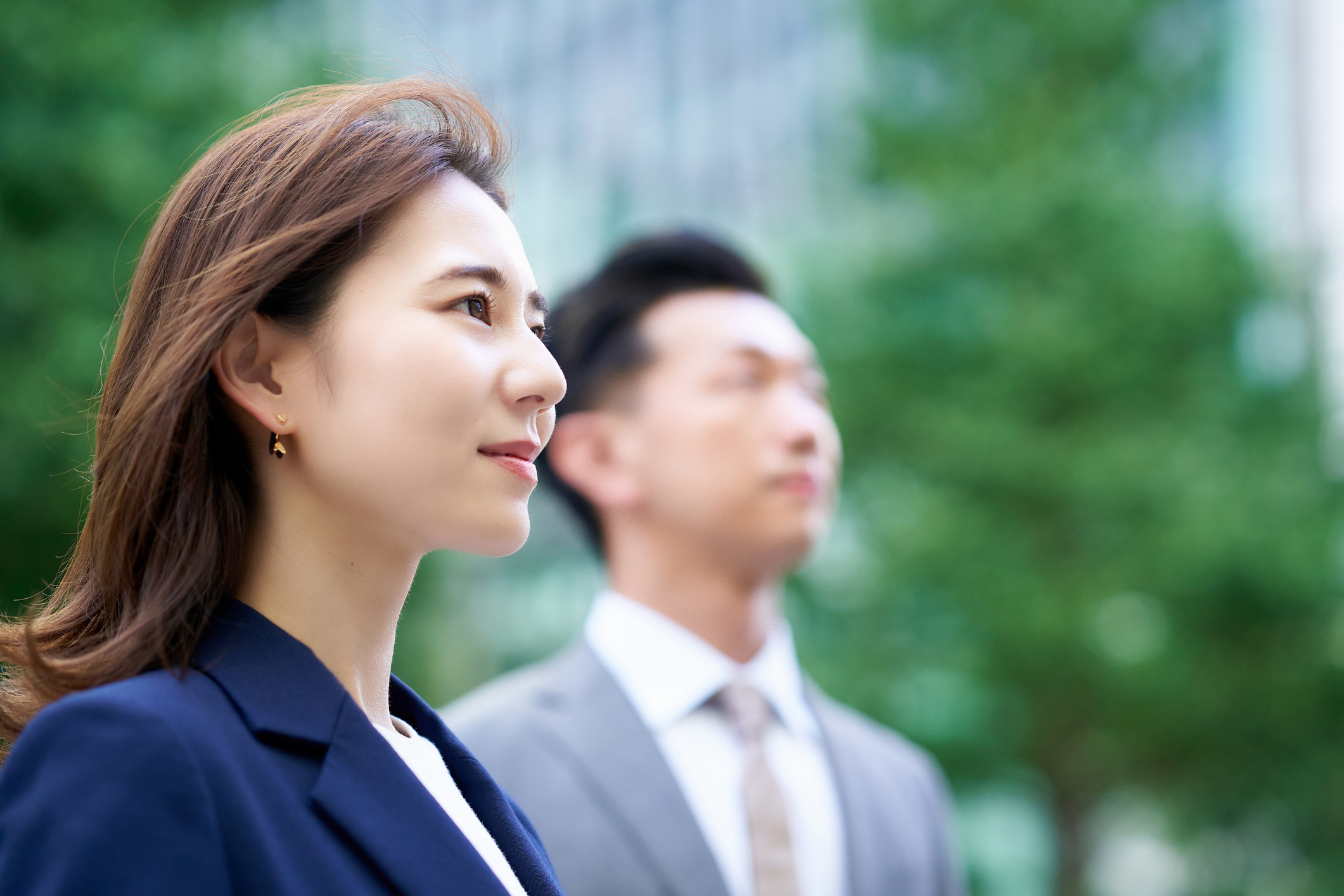 asian business man and woman outdoors